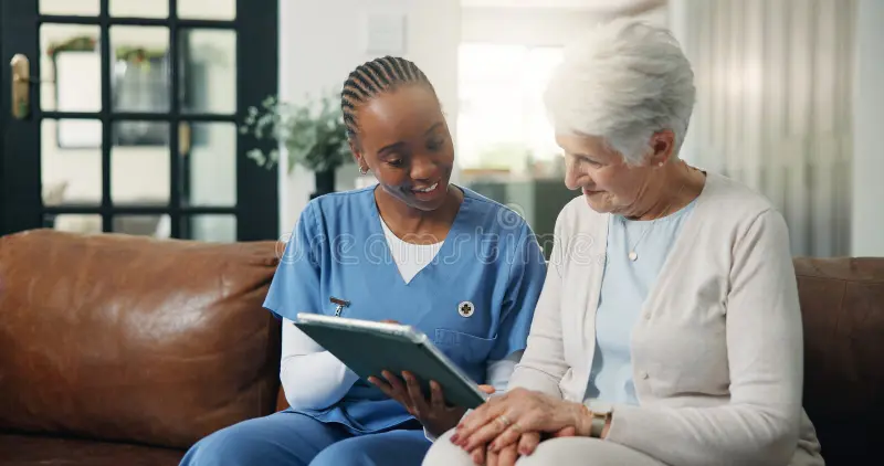 Medical team conducting a home health consultation in Moshi